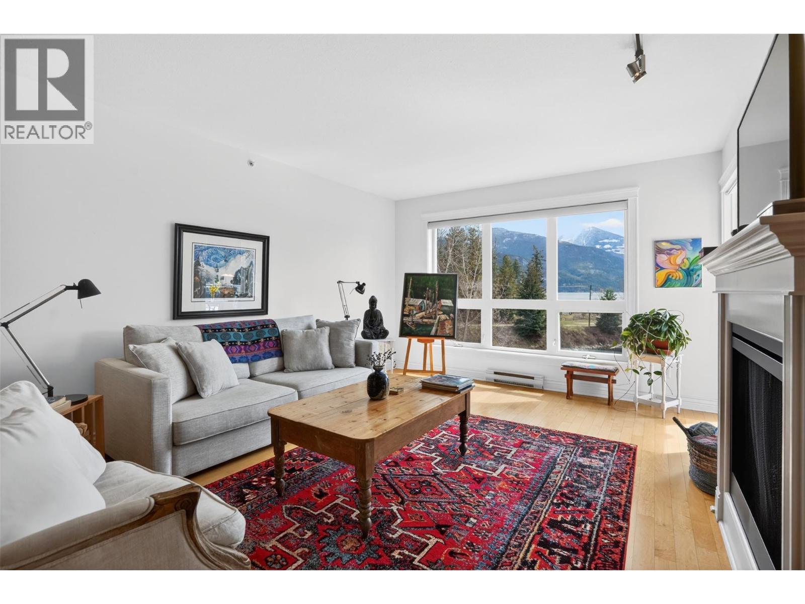 550 Rainbow Drive Unit# 302, Kaslo, BC - Indoor Photo Showing Living Room With Fireplace
