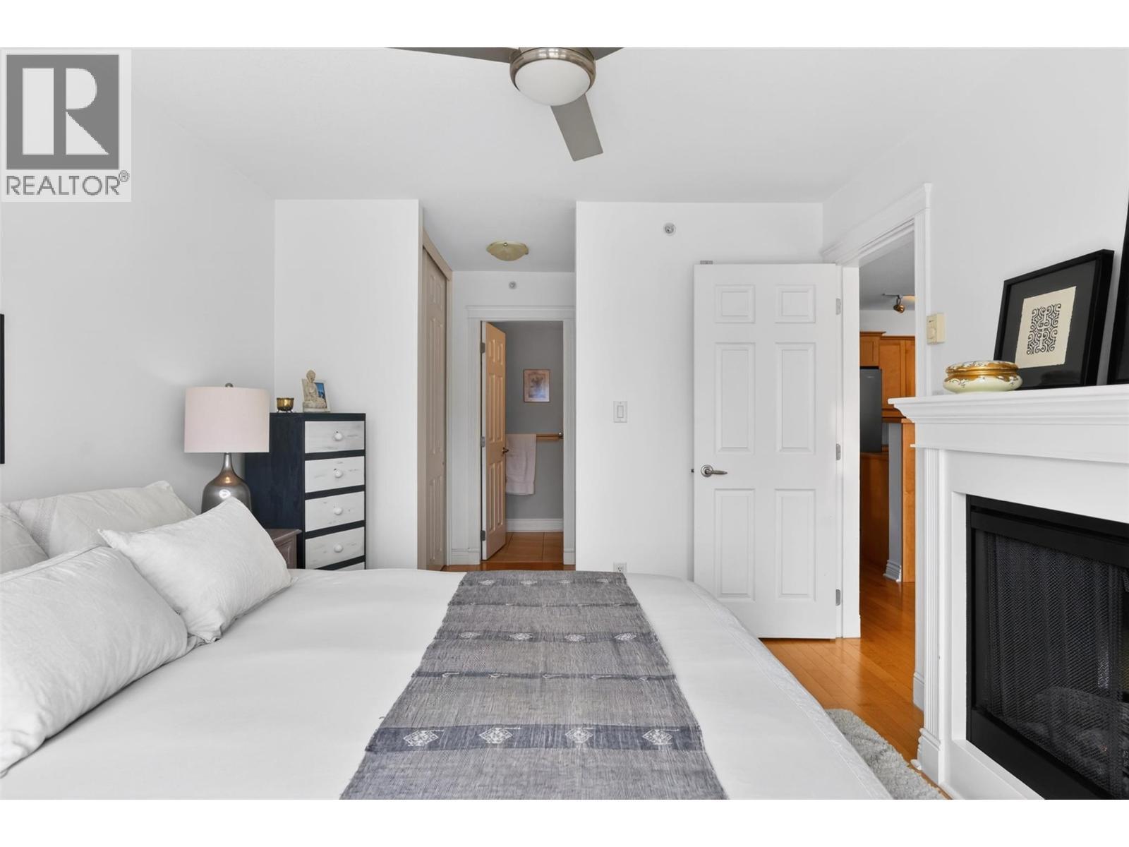 550 Rainbow Drive Unit# 302, Kaslo, BC - Indoor Photo Showing Bedroom With Fireplace
