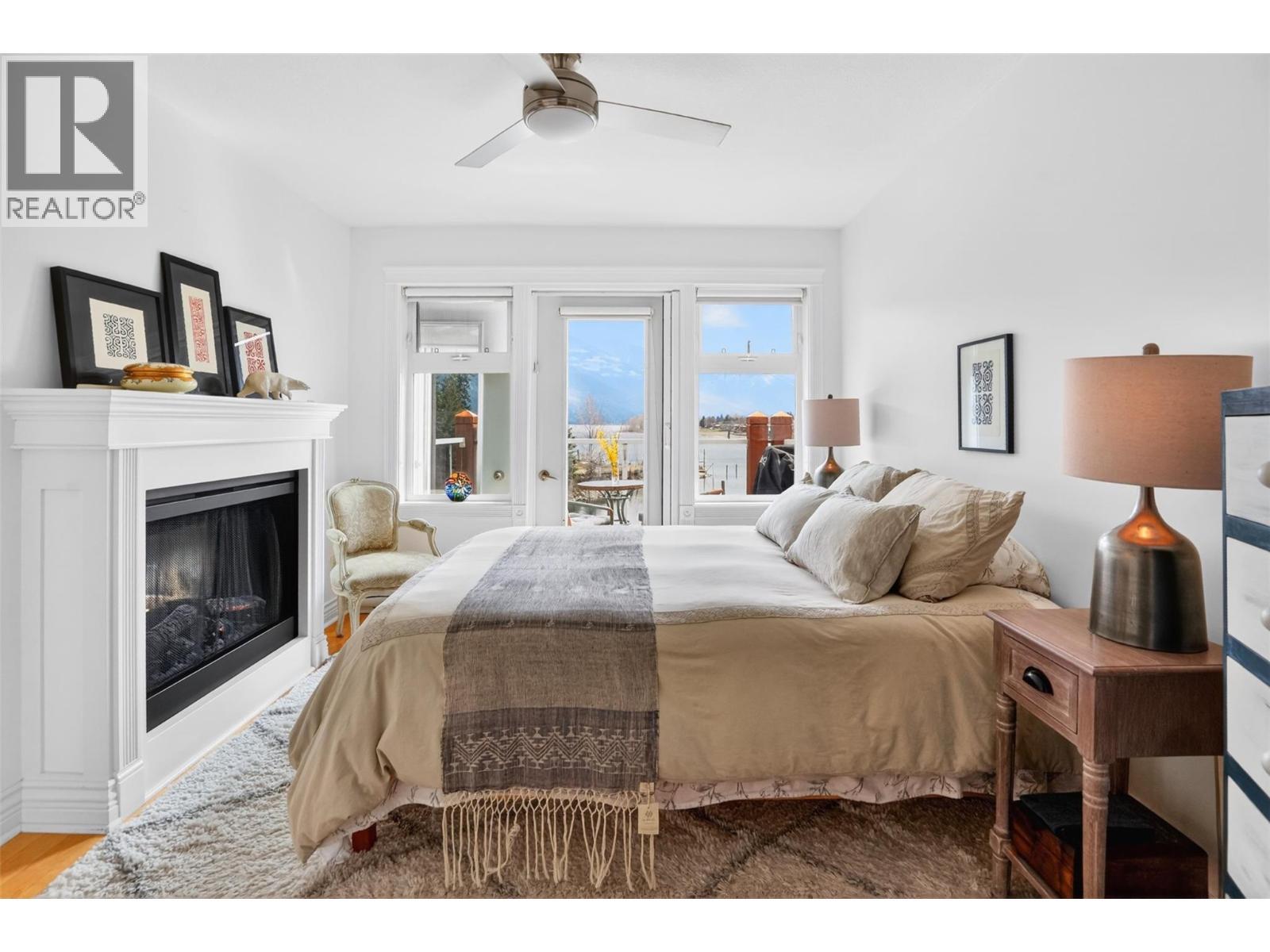 550 Rainbow Drive Unit# 302, Kaslo, BC - Indoor Photo Showing Bedroom With Fireplace