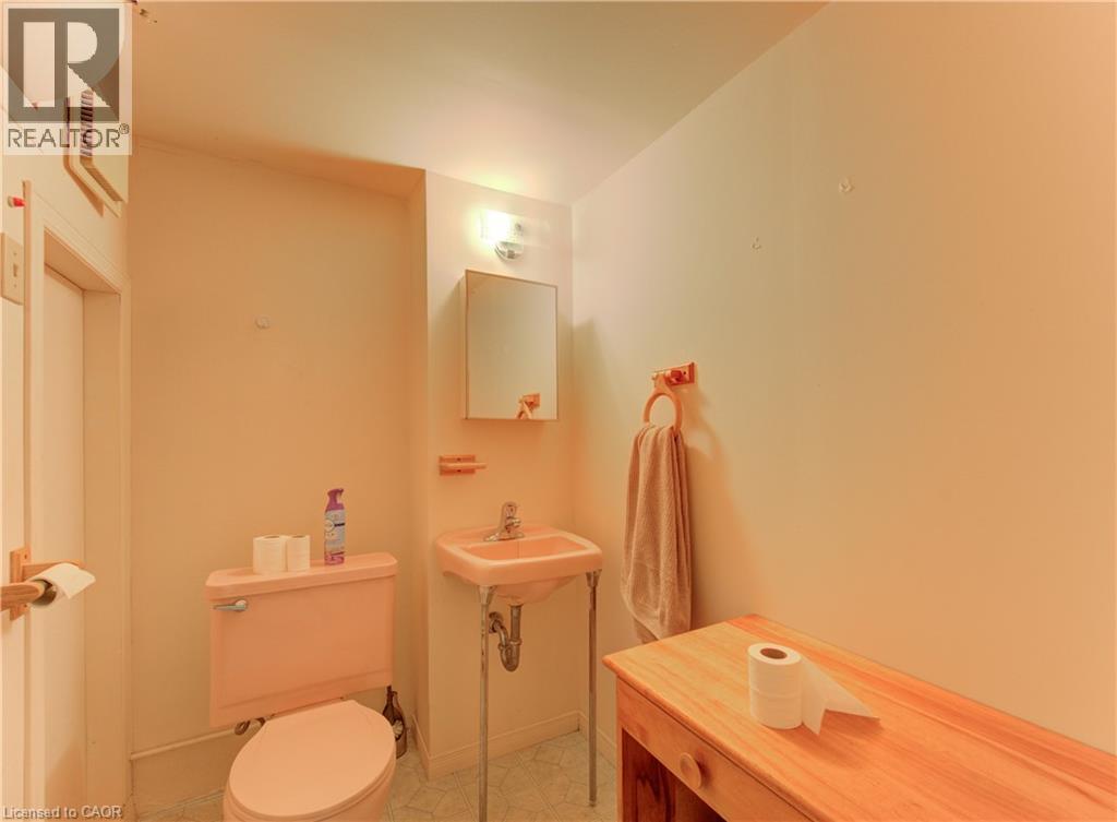 Bathroom featuring a pink toilet and matching pedestal sink - 98 Shea Crescent, Kitchener, ON - Indoor Photo Showing Bathroom