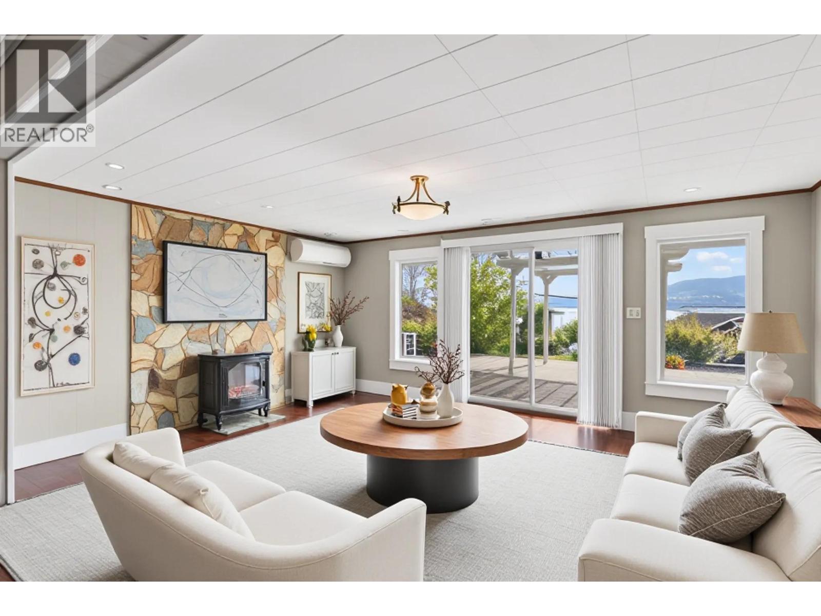 **virtually staged** - 3940 Angus Drive, West Kelowna, BC - Indoor Photo Showing Living Room With Fireplace