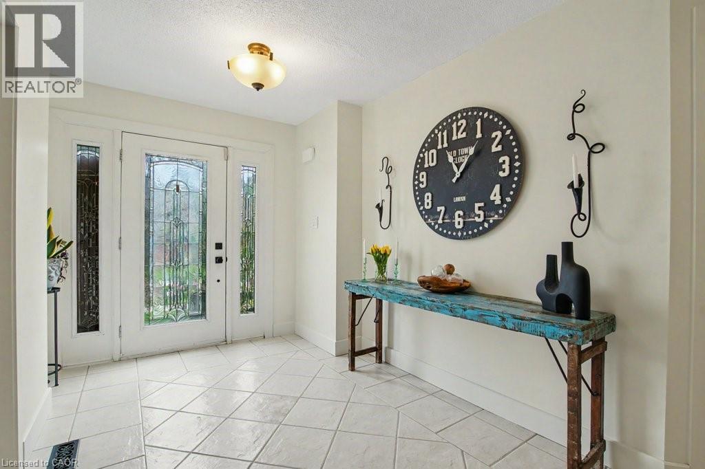 Entryway featuring a white door with decorative glass inserts, flanked by sidelight windows - 2324 Homer Drive, Burlington, ON - Indoor Photo Showing Living Room