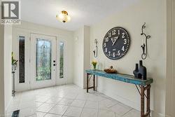 Entryway featuring a white door with decorative glass inserts, flanked by sidelight windows -
