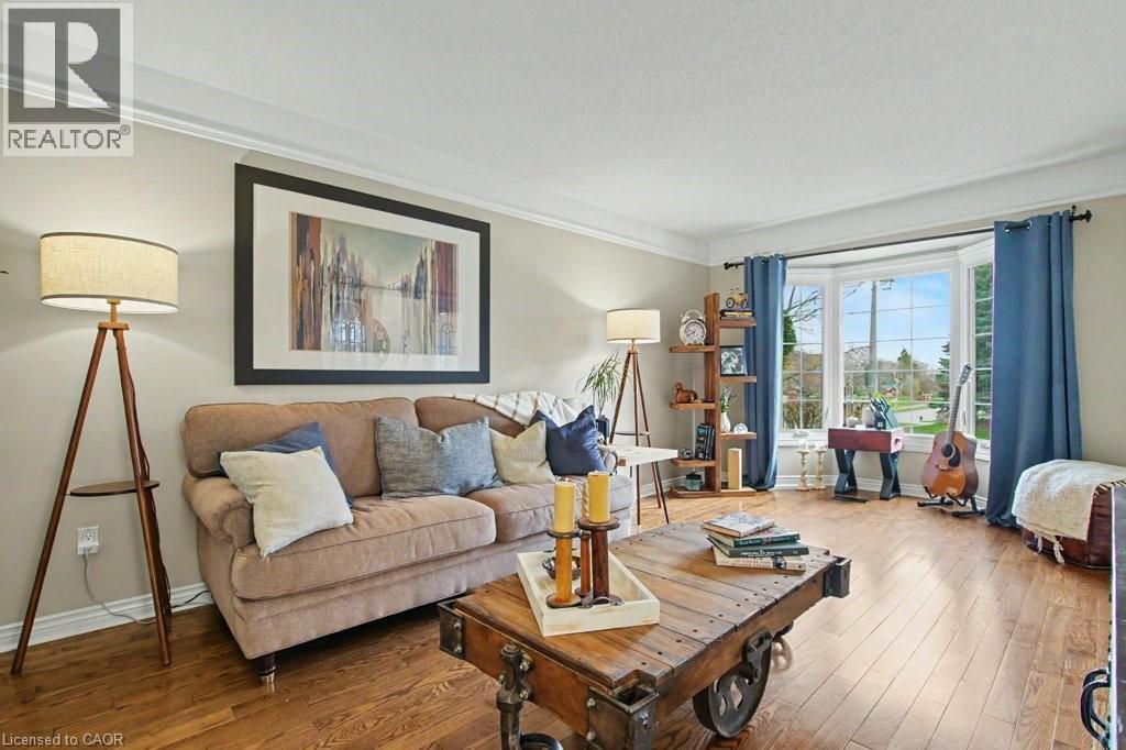 Bay window with multiple panes, crown molding, wood-finish flooring, and light wall tones - 2324 Homer Drive, Burlington, ON - Indoor Photo Showing Office