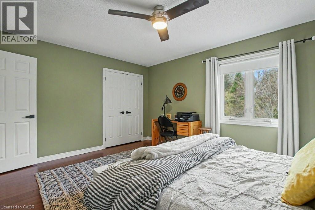 Spacious room with wood-finish flooring, a ceiling fan, and a large window - 2324 Homer Drive, Burlington, ON - Indoor Photo Showing Bathroom