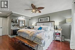 Hardwood-finish flooring featuring painted walls and white crown molding -