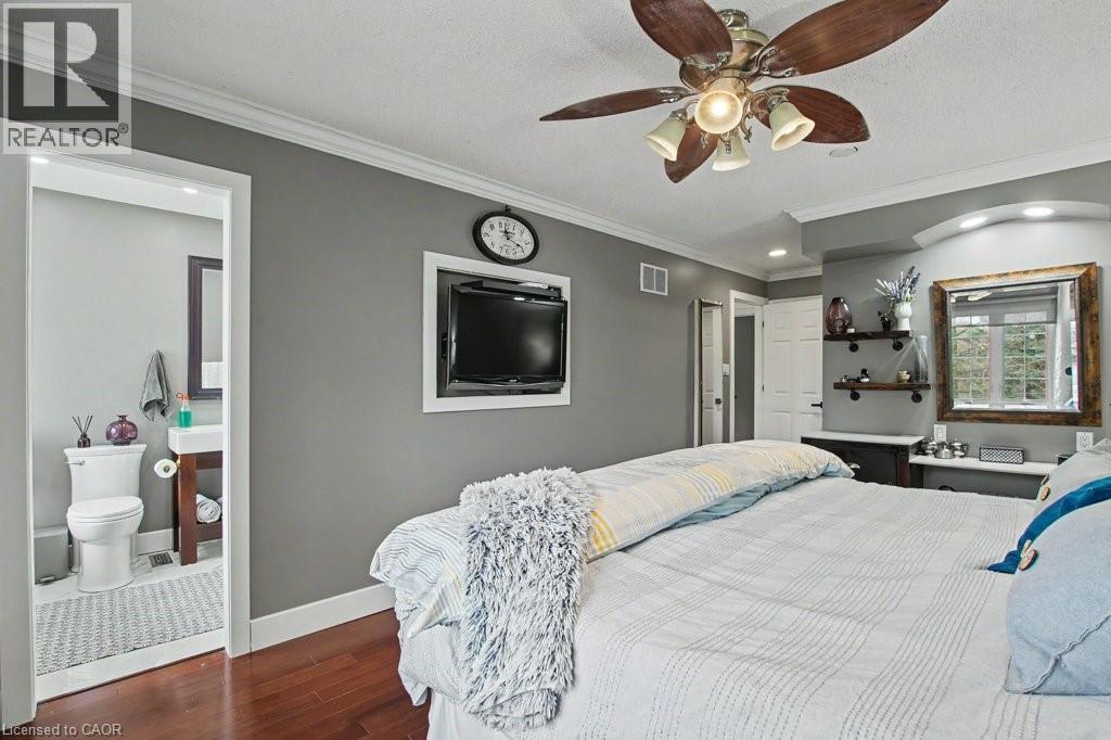 Bedroom featuring wood-finish flooring, a ceiling fan with integrated lighting, and crown molding - 2324 Homer Drive, Burlington, ON - Indoor Photo Showing Bathroom