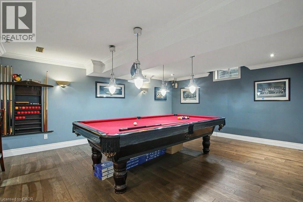 Recreation room featuring wood-finish flooring and crown molding - 2324 Homer Drive, Burlington, ON - Indoor
