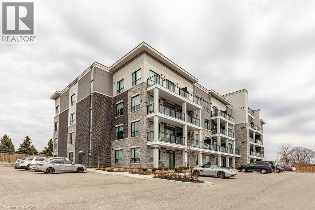 Contemporary multi-story building featuring brick and stone cladding - 120 Springvalley Crescent Unit# 208, Hamilton, ON - Outdoor With Balcony With Facade
