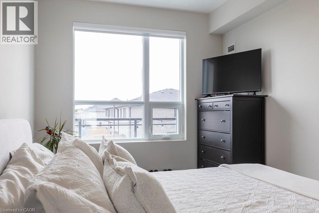 Expansive window with white frames - 120 Springvalley Crescent Unit# 208, Hamilton, ON - Indoor Photo Showing Bedroom