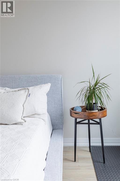 Light gray wall paint complemented by light wood-finish flooring - 120 Springvalley Crescent Unit# 208, Hamilton, ON -
