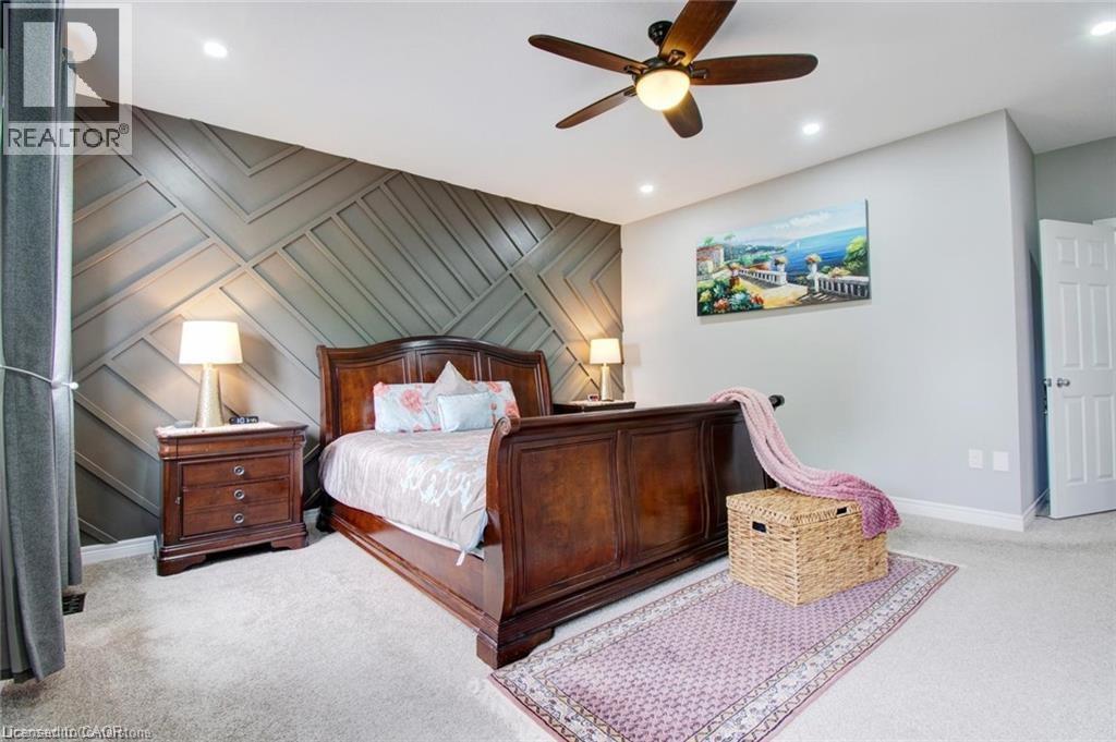 Bedroom featuring an accent wall, a ceiling fan, light carpet, and recessed lighting - 49 Scots Pine Trail, Kitchener, ON - Indoor Photo Showing Bedroom