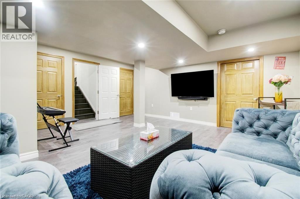 Recreation room with stairway, recessed lighting, and wood finished floors - 49 Scots Pine Trail, Kitchener, ON - Indoor