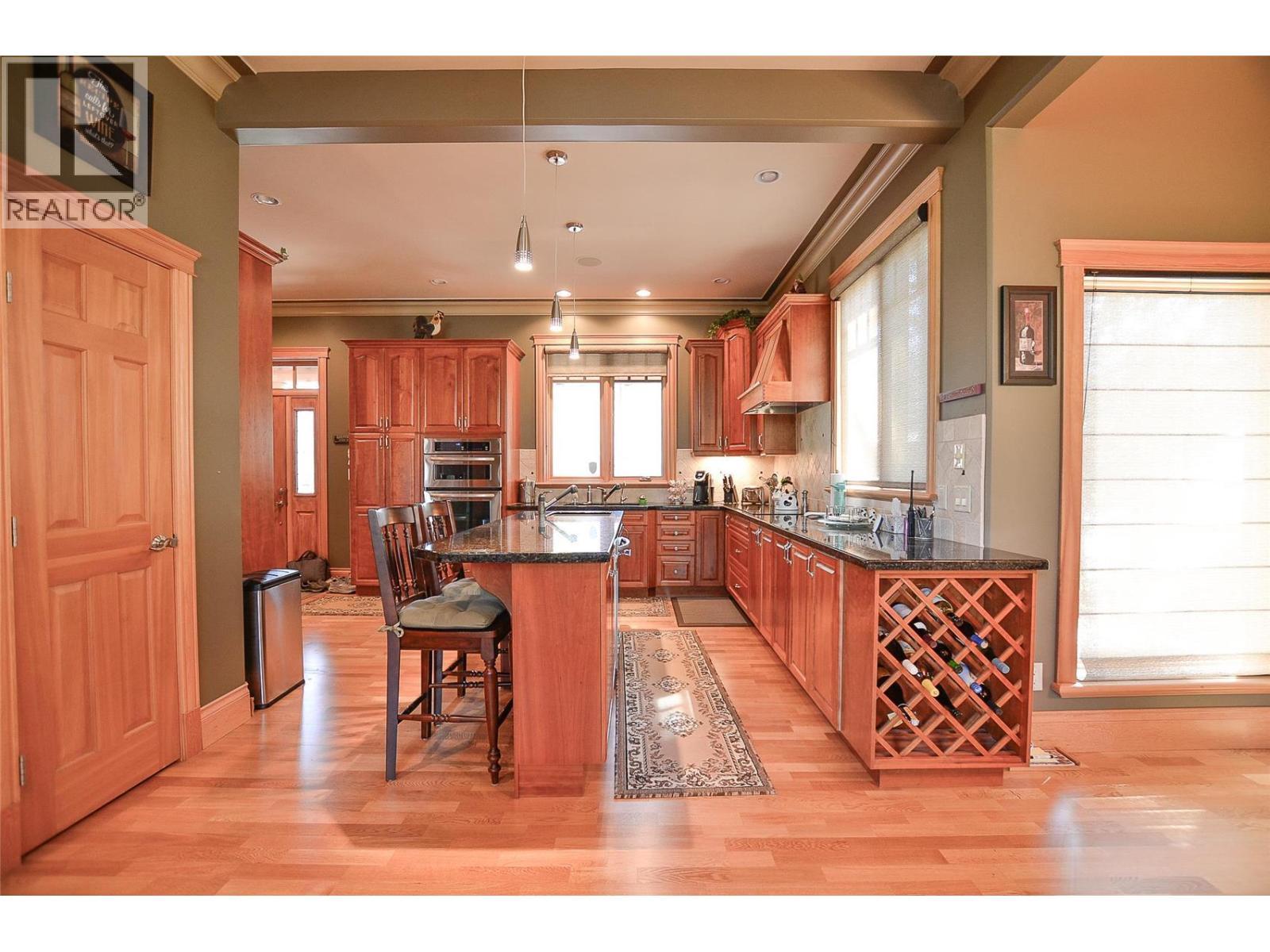 Built in wine storage, large pantry, built in vac on both floors, and heated floors are just some of the features you'll appreciate! - 19-3453 Cessna Road, Enderby, BC - Indoor Photo Showing Kitchen