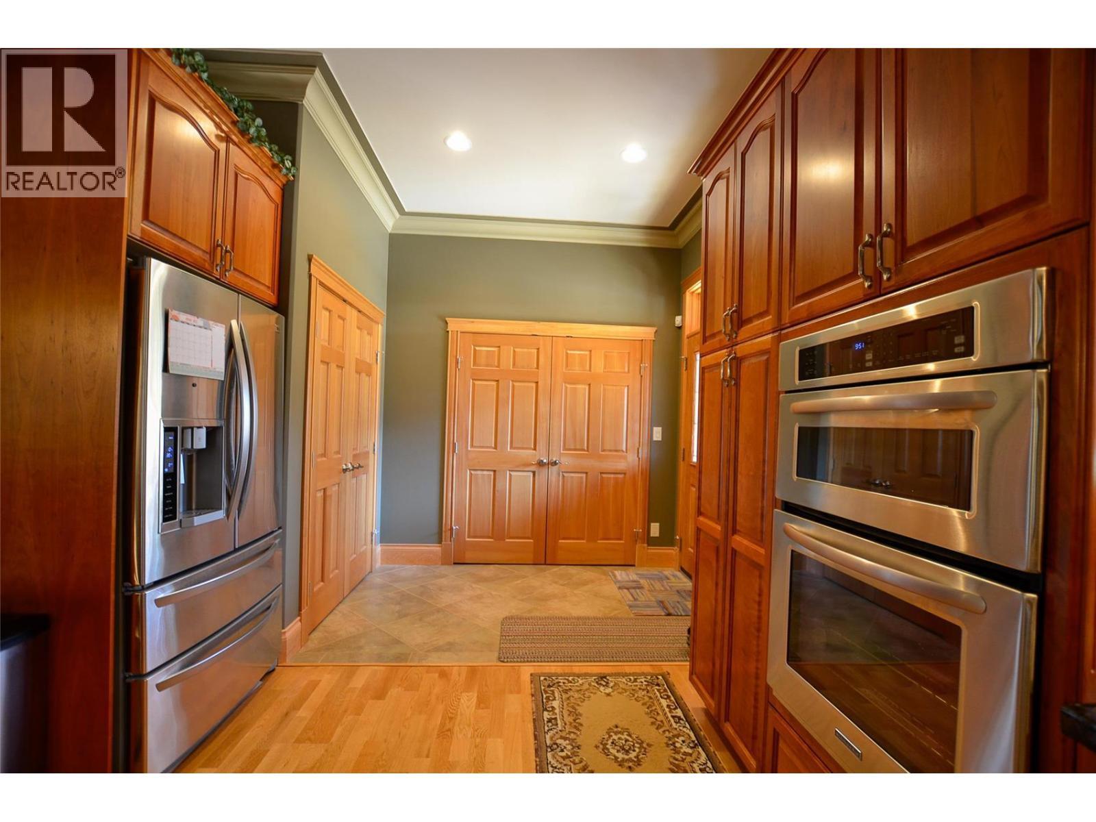 Double over, large fridge and freezer with laundry in the entry closet - 19-3453 Cessna Road, Enderby, BC - Indoor Photo Showing Kitchen