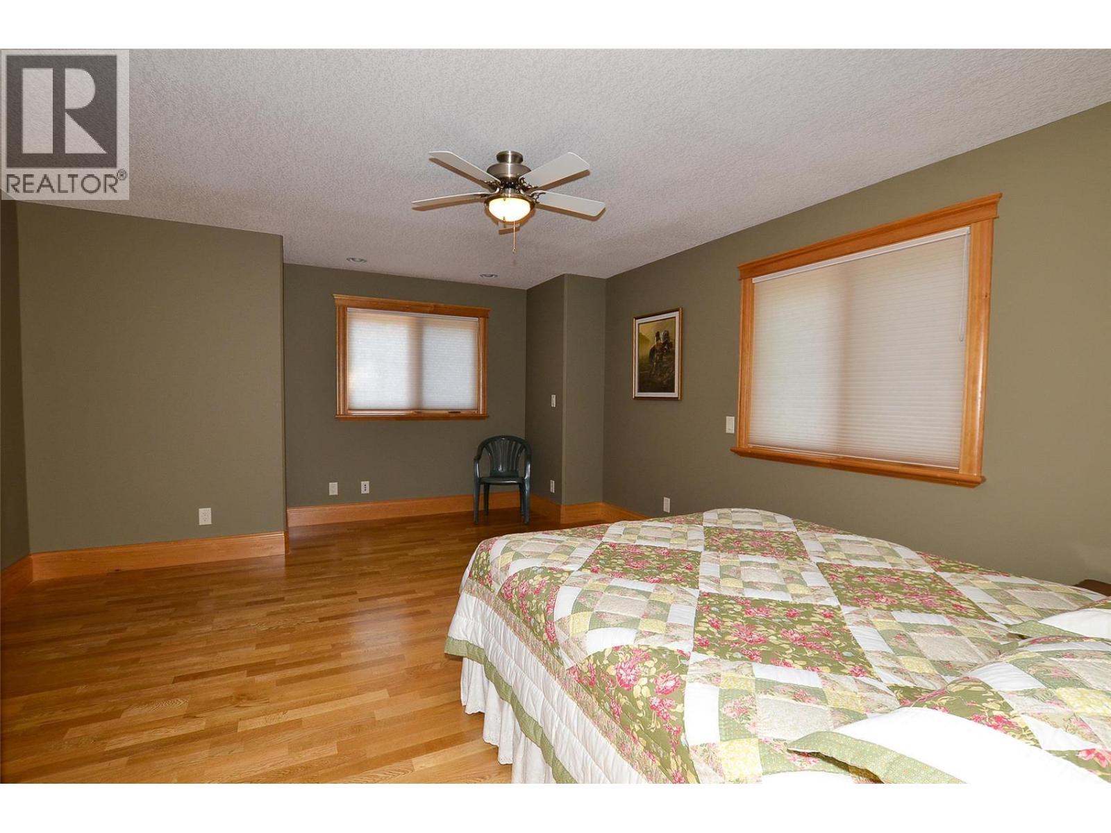 Windows and fans in the upstairs bedrooms add year-round comfort. - 19-3453 Cessna Road, Enderby, BC - Indoor Photo Showing Bedroom