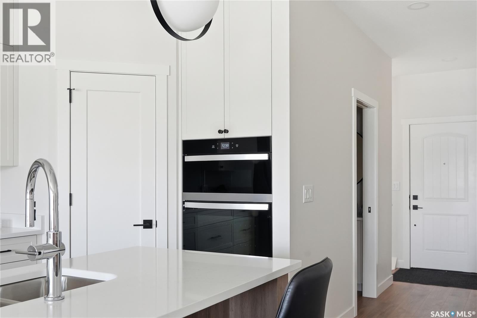 22 720 Brighton Boulevard, Saskatoon, SK - Indoor Photo Showing Kitchen With Double Sink
