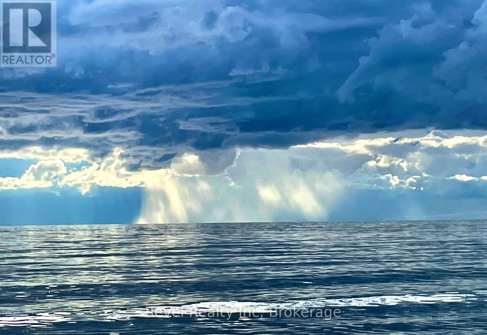 amazing view of Blue Mountain across the lake - 12 Walker Road, Tiny, ON - Outdoor With Body Of Water With View