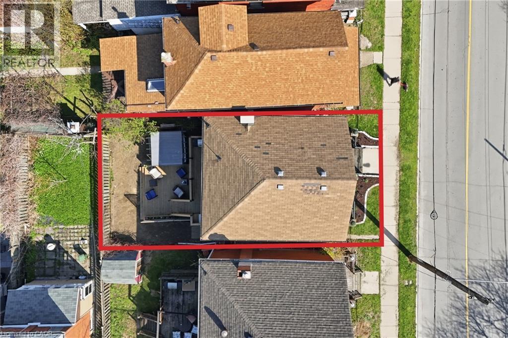 Property features a private backyard deck, a fenced perimeter, and a detached shed - 361 Cumberland Avenue, Hamilton, ON - Outdoor With Exterior