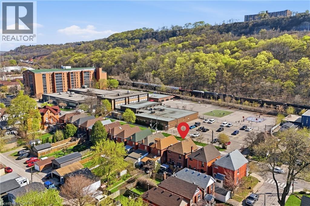Aerial view showcasing a residential neighborhood with brick homes, featuring mature trees and established landscaping - 361 Cumberland Avenue, Hamilton, ON - Outdoor With View