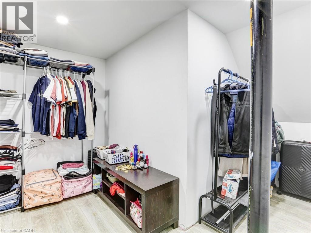 Recessed lighting illuminates this room featuring light wood-finish flooring - 154 Deerpath Drive, Guelph, ON - Indoor With Storage