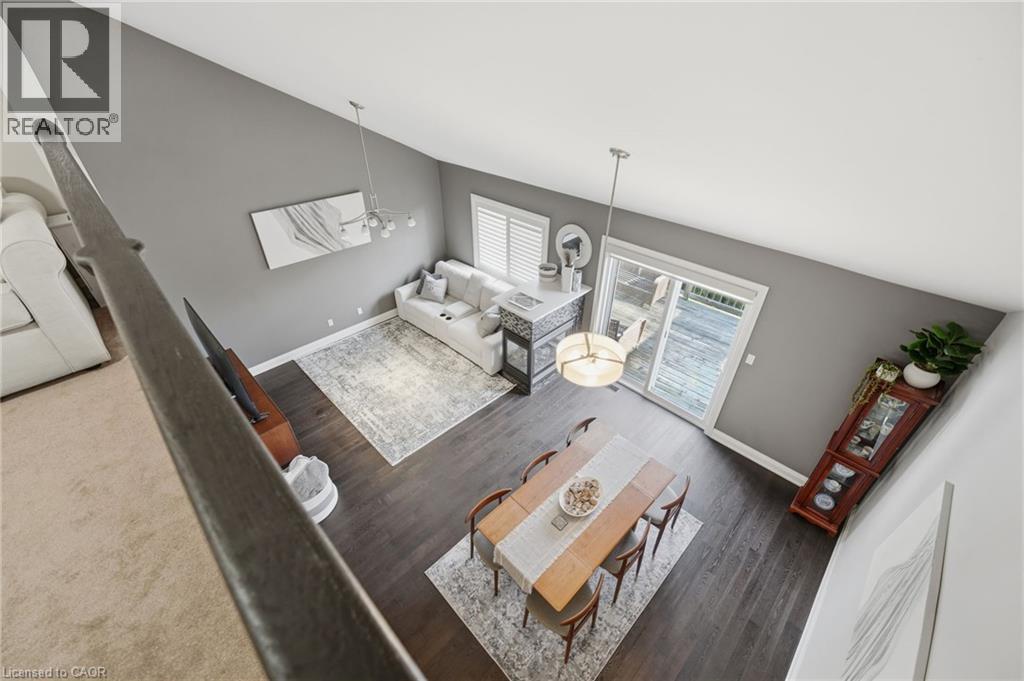 Vaulted ceiling with modern chandelier and pendant lighting fixtures - 7 Gibson Place Unit# 26, St. Catharines, ON - Indoor Photo Showing Other Room