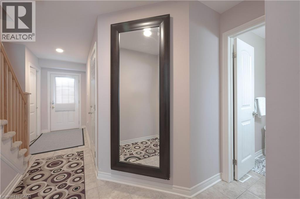 Hallway featuring light tile patterned floors, stairway, and recessed lighting - 535 Margaret Street Unit# 74, Cambridge, ON - Indoor Photo Showing Other Room