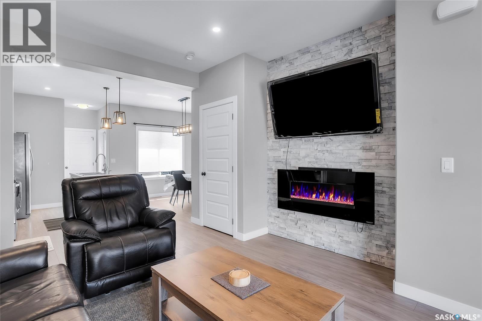 608 Brighton Gate, Saskatoon, SK - Indoor Photo Showing Living Room With Fireplace