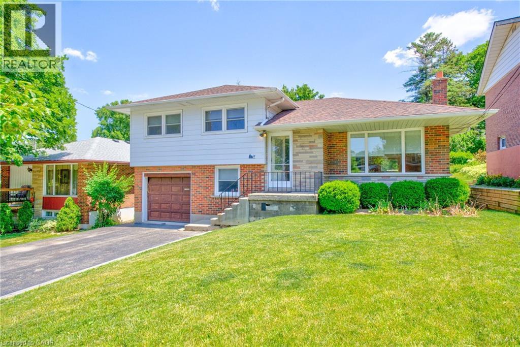 Split-level residence featuring a brick and stone facade with white siding - 31 Brodick Street, Hamilton, ON - Outdoor With Deck Patio Veranda With Facade