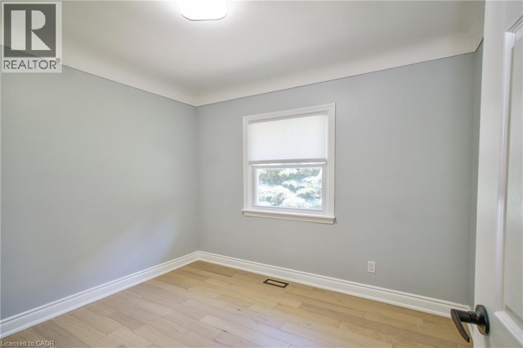 Room featuring light wood-finish flooring, light gray wall paint, and white trim molding - 31 Brodick Street, Hamilton, ON - Indoor Photo Showing Other Room