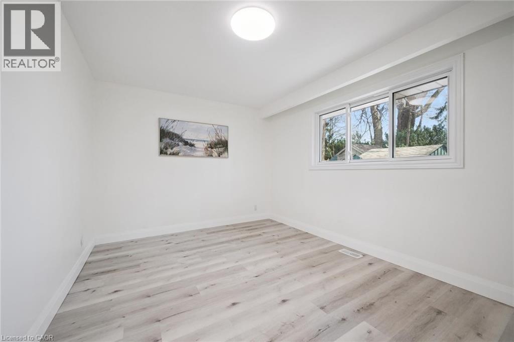Interior room featuring light wood-finish flooring, white walls, and a multi-pane window with white trim - 27 Silverspring Crescent, Kitchener, ON - Indoor Photo Showing Other Room