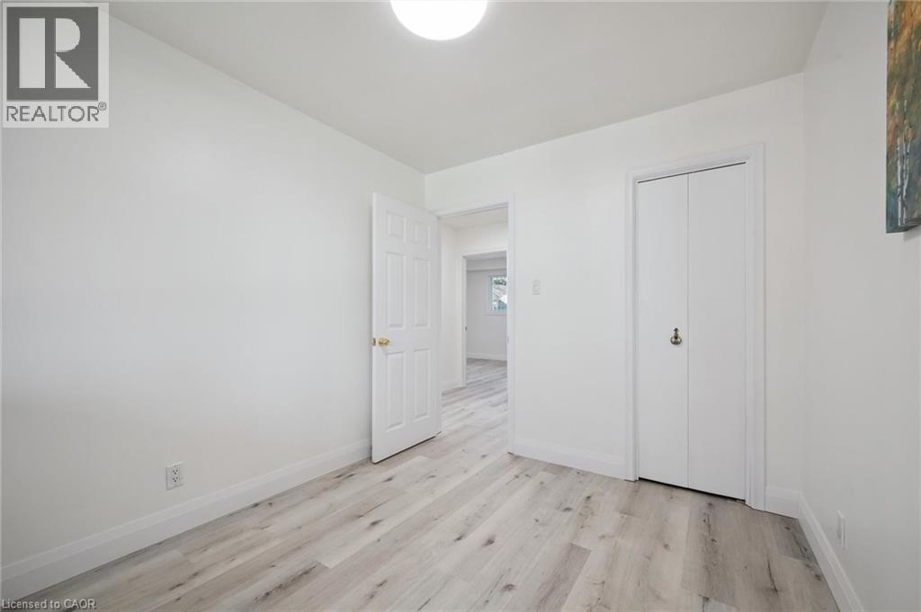 Room featuring light wood-finish flooring, white walls, and a flush-mount ceiling light - 27 Silverspring Crescent, Kitchener, ON - Indoor Photo Showing Other Room