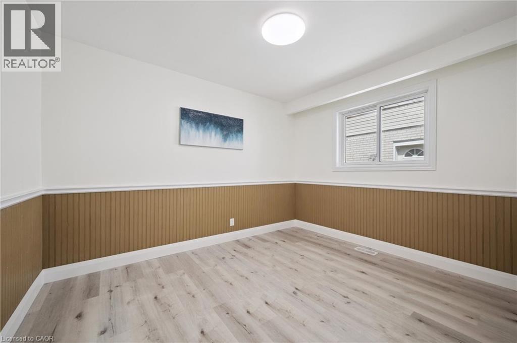 Room featuring light wood-finish flooring and a window with white trim - 27 Silverspring Crescent, Kitchener, ON - Indoor Photo Showing Other Room