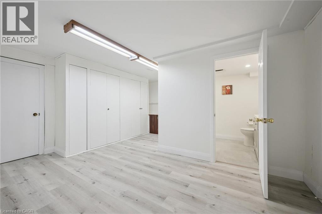Room featuring light wood-finish flooring, white walls, and built-in white cabinetry - 27 Silverspring Crescent, Kitchener, ON - Indoor Photo Showing Other Room