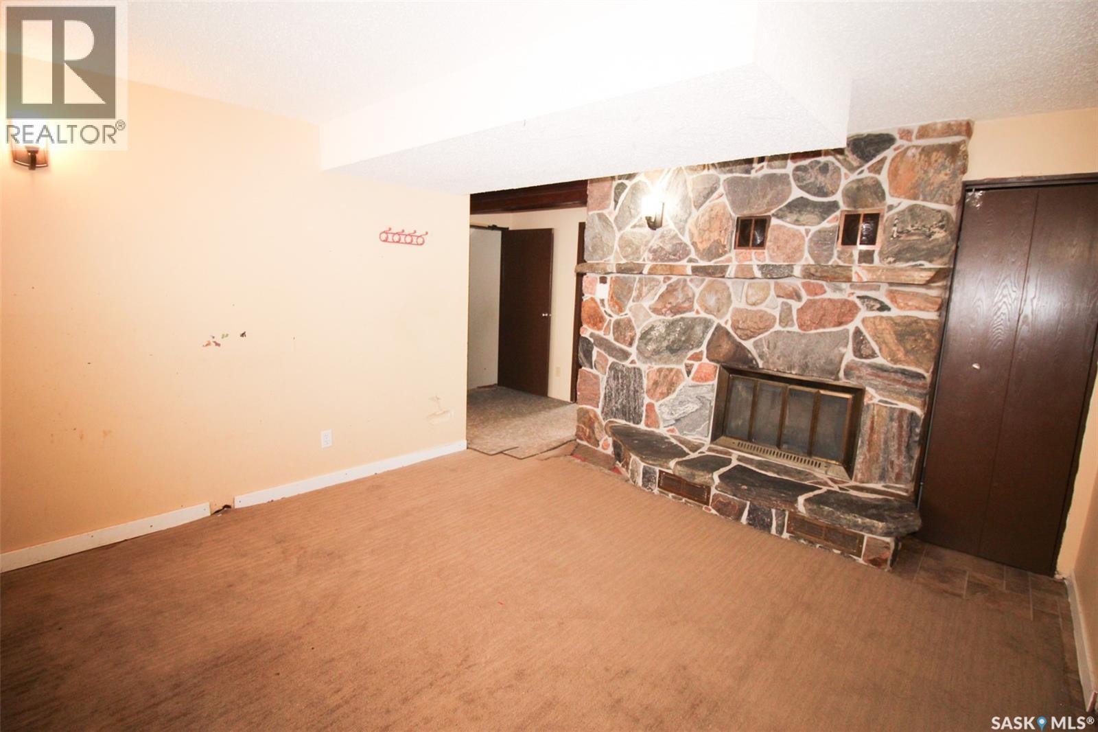 504 3Rd Avenue E, Frontier, SK - Indoor Photo Showing Other Room With Fireplace
