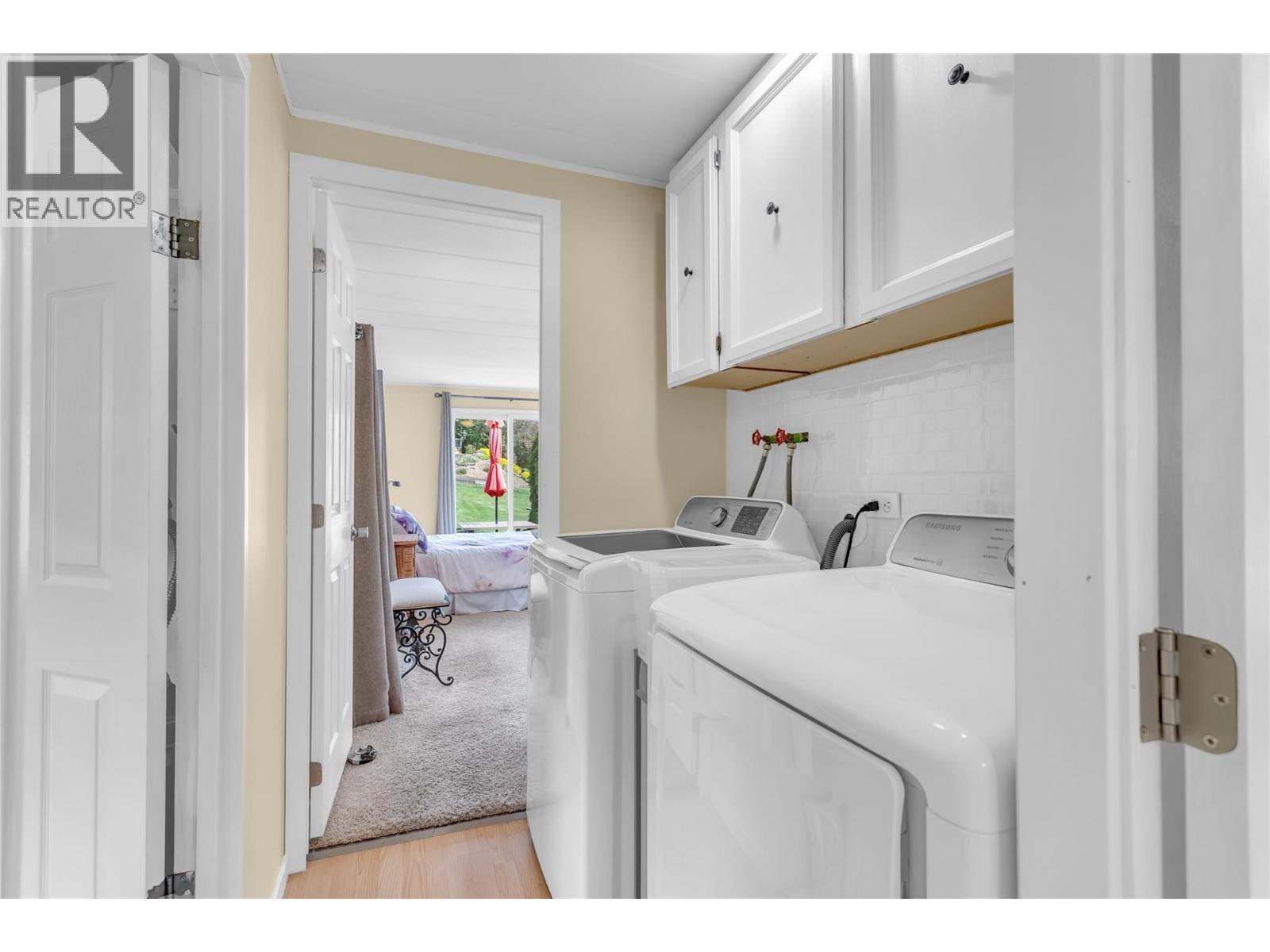 Laundry area between the bathroom and primary bedroom - 12022 Pretty Road Unit# 16, Lake Country, BC