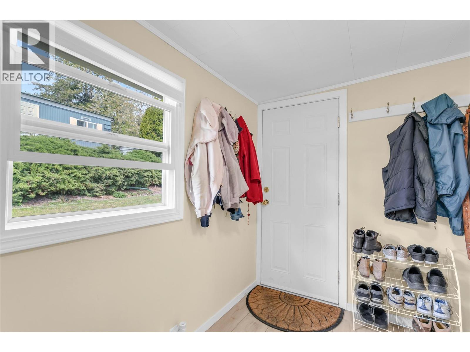 Den or mud room with a door to access the back yard and workshop. - 12022 Pretty Road Unit# 16, Lake Country, BC