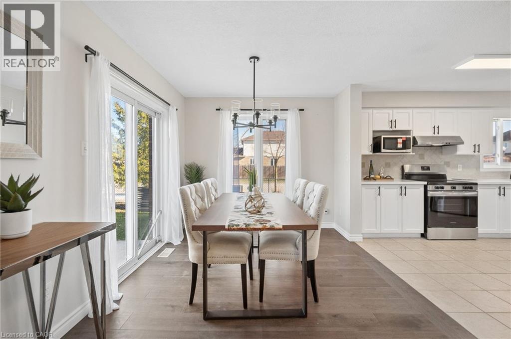 Dining space featuring hanging lights, light wood-style flooring, and healthy amount of natural light - 649 Doon South Drive, Kitchener, ON - Indoor