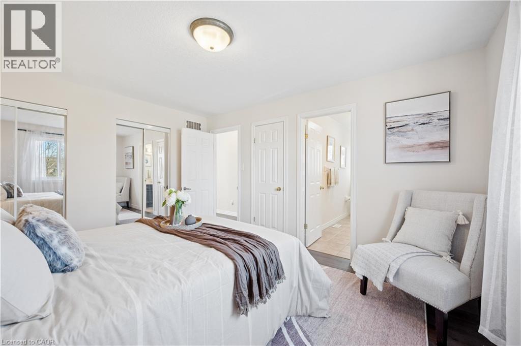 Bedroom featuring two closets and connected bathroom - 649 Doon South Drive, Kitchener, ON - Indoor Photo Showing Bedroom
