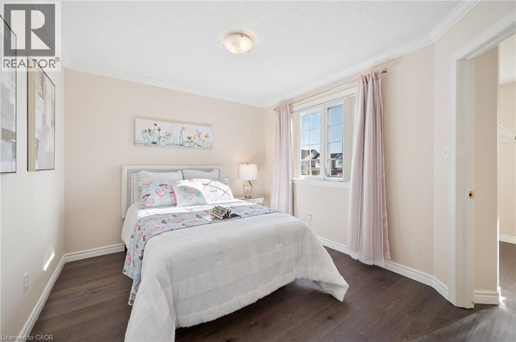 Bedroom with dark wood-type flooring and crown molding - 649 Doon South Drive, Kitchener, ON - Indoor Photo Showing Bedroom