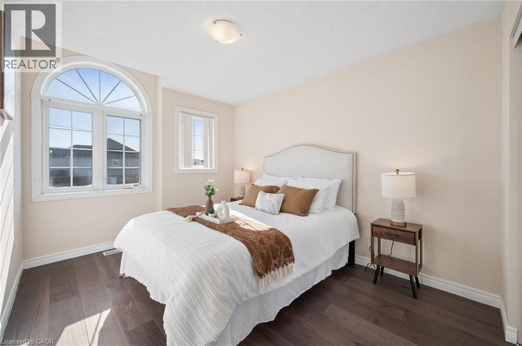 Bedroom featuring dark wood-style flooring and baseboards - 649 Doon South Drive, Kitchener, ON - Indoor Photo Showing Bedroom