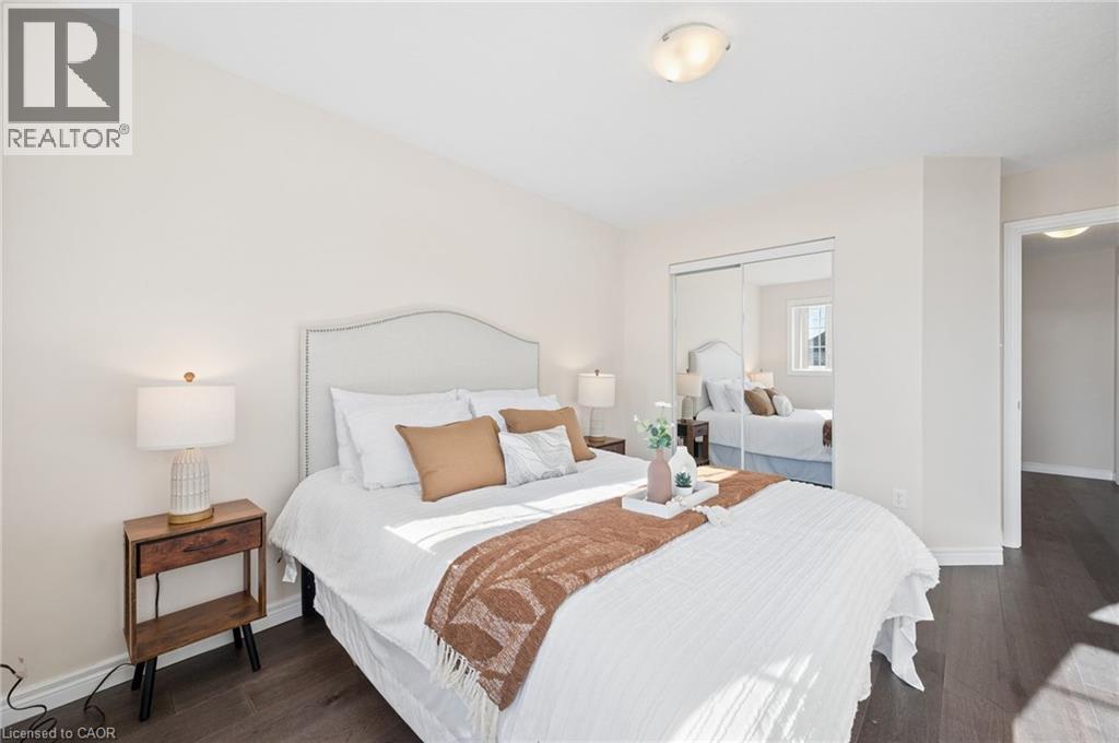 Bedroom featuring a closet and dark wood-type flooring - 649 Doon South Drive, Kitchener, ON - Indoor Photo Showing Bedroom