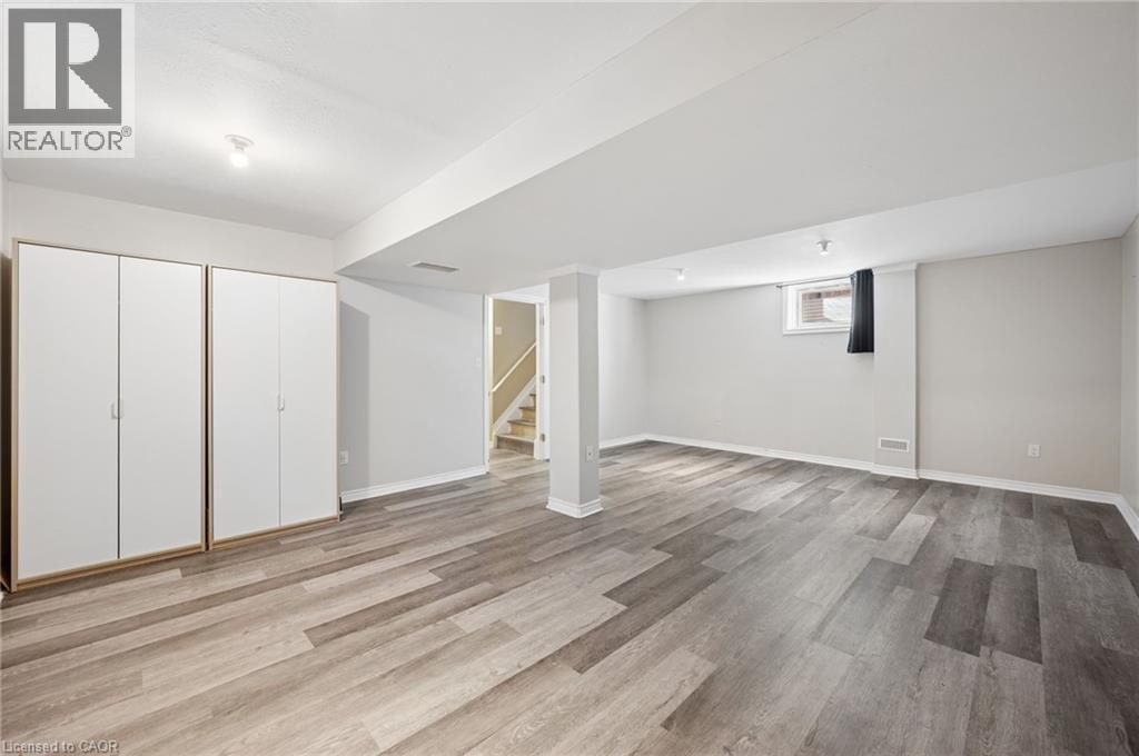 Below grade area featuring stairway and light wood finished floors - 649 Doon South Drive, Kitchener, ON - Indoor