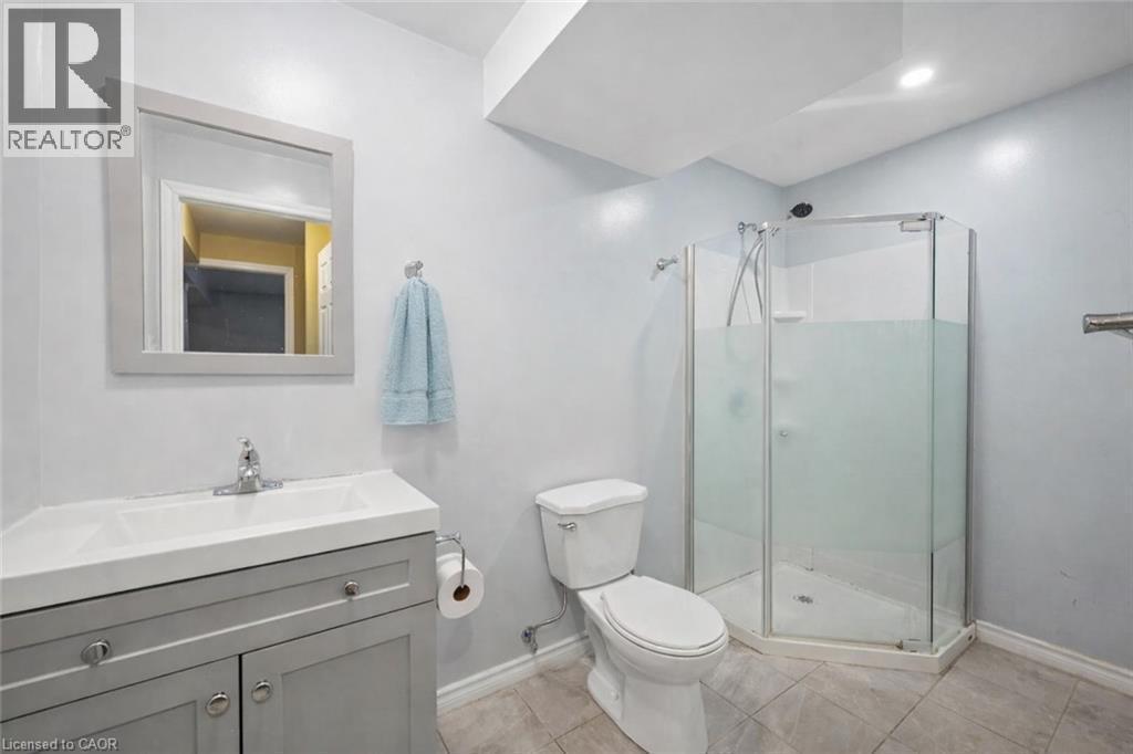 Full bathroom featuring vanity, a stall shower, and light tile patterned floors - 649 Doon South Drive, Kitchener, ON - Indoor Photo Showing Bathroom
