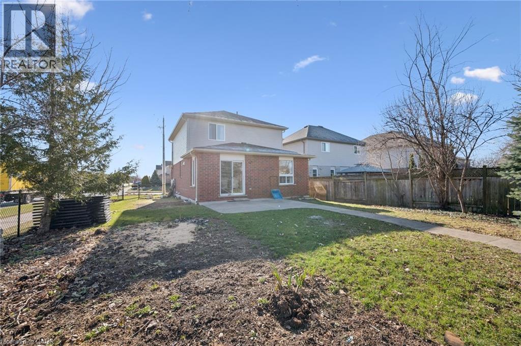 Back of house with brick siding, a fenced backyard, and a patio area - 649 Doon South Drive, Kitchener, ON - Outdoor