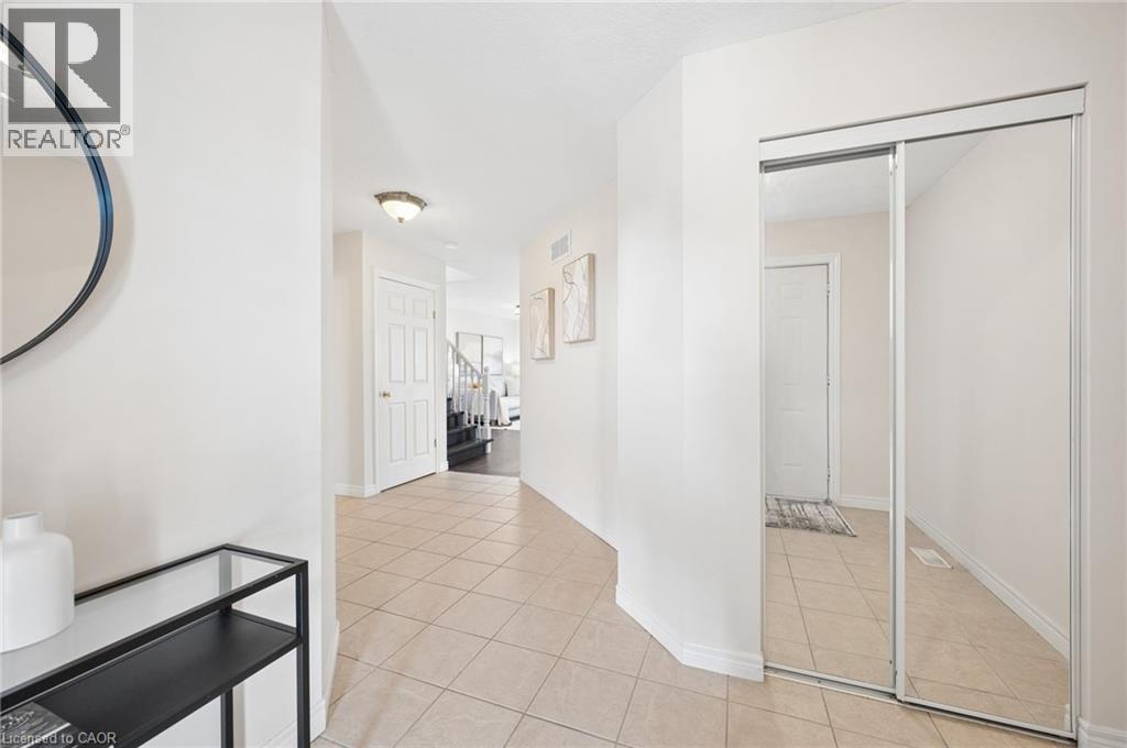 Corridor with light tile patterned flooring and baseboards - 649 Doon South Drive, Kitchener, ON - Indoor Photo Showing Other Room