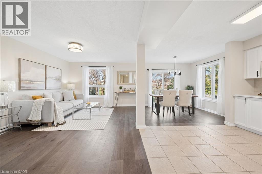 Living area with light wood-style flooring and baseboards - 649 Doon South Drive, Kitchener, ON - Indoor