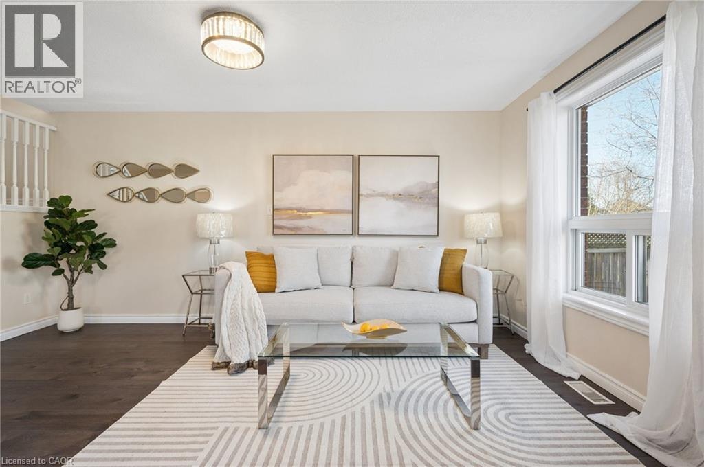 Living area featuring dark wood-type flooring and baseboards - 649 Doon South Drive, Kitchener, ON - Indoor Photo Showing Living Room