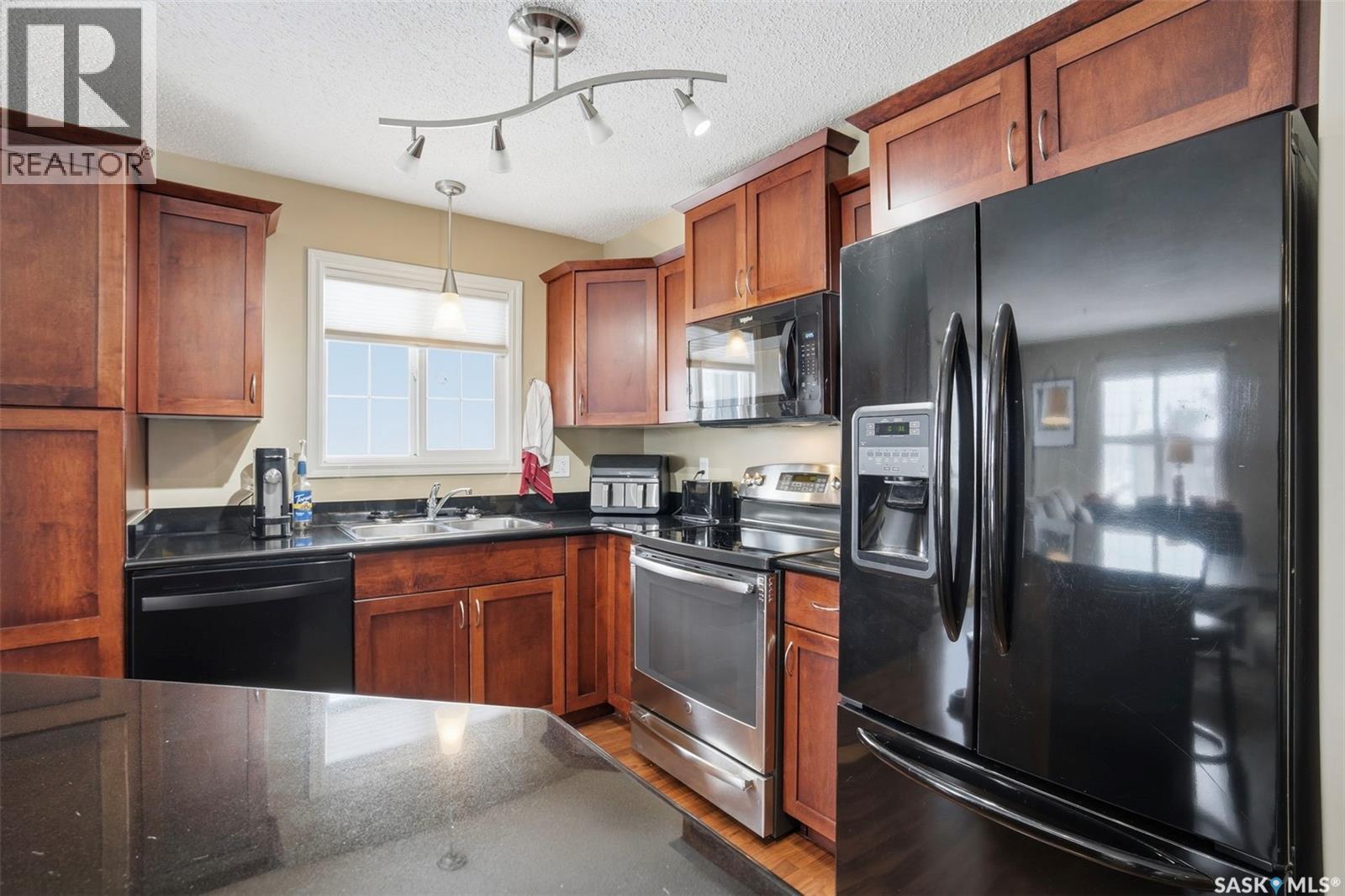 A206 103 Wellman Crescent, Saskatoon, SK - Indoor Photo Showing Kitchen With Double Sink