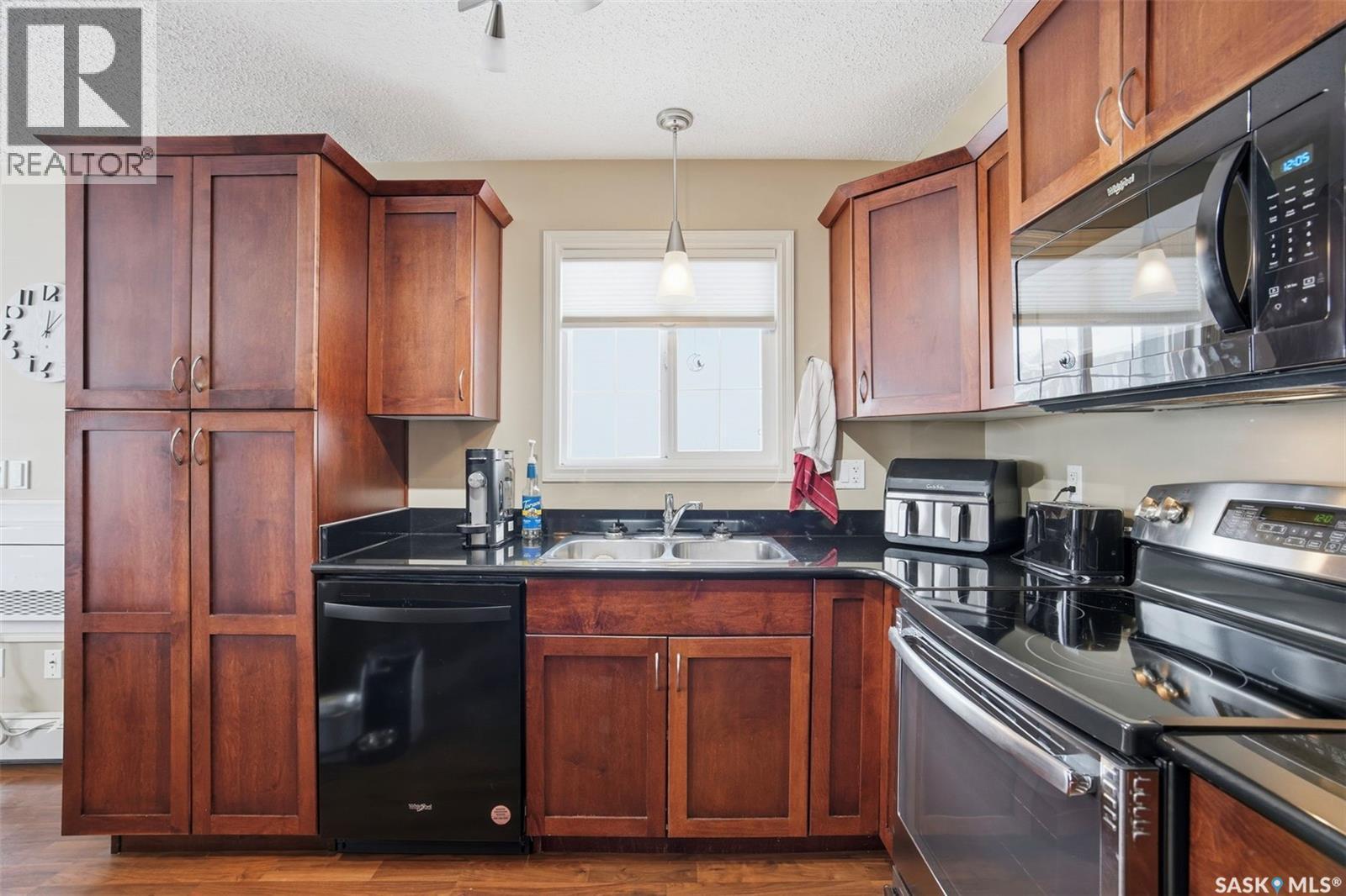 A206 103 Wellman Crescent, Saskatoon, SK - Indoor Photo Showing Kitchen With Double Sink